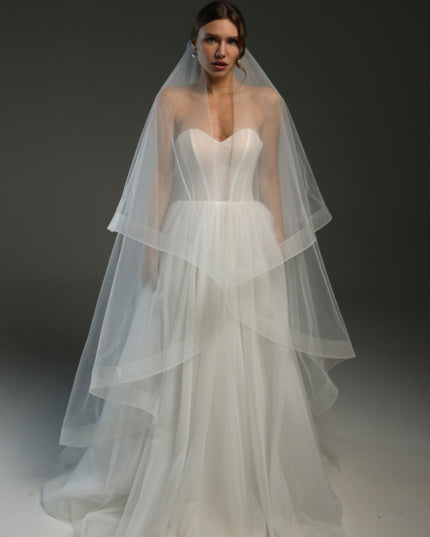 Ivory bridal veil made from soft English tulle, fingertip length, featuring two layers and a horsehair trim.