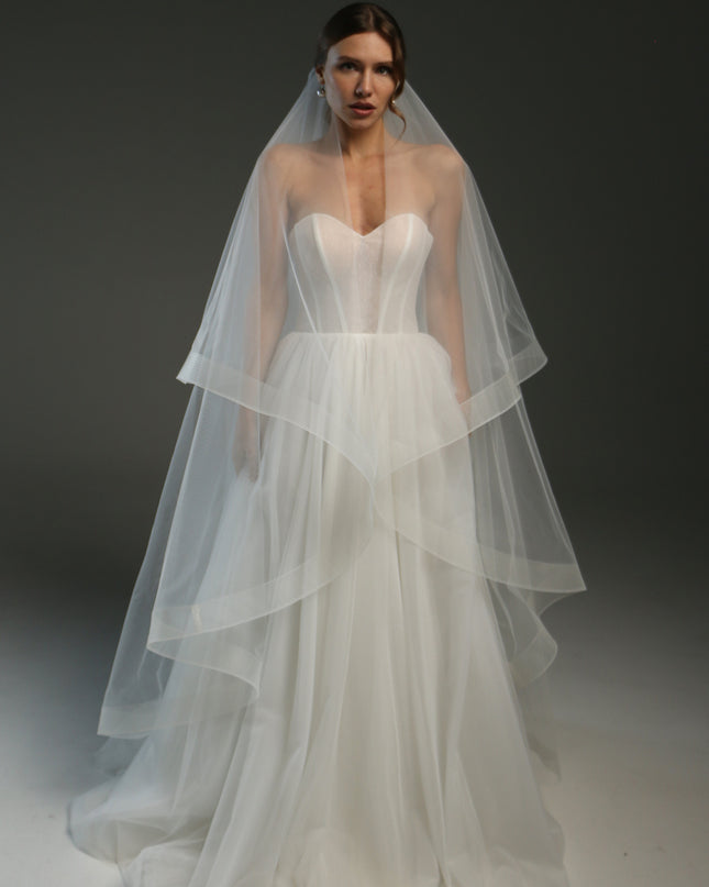 Ivory bridal veil made from soft English tulle, fingertip length, featuring two layers and a horsehair trim.