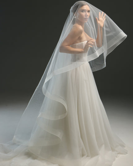 Ivory bridal veil made from soft English tulle, fingertip length, featuring two layers and a horsehair trim.