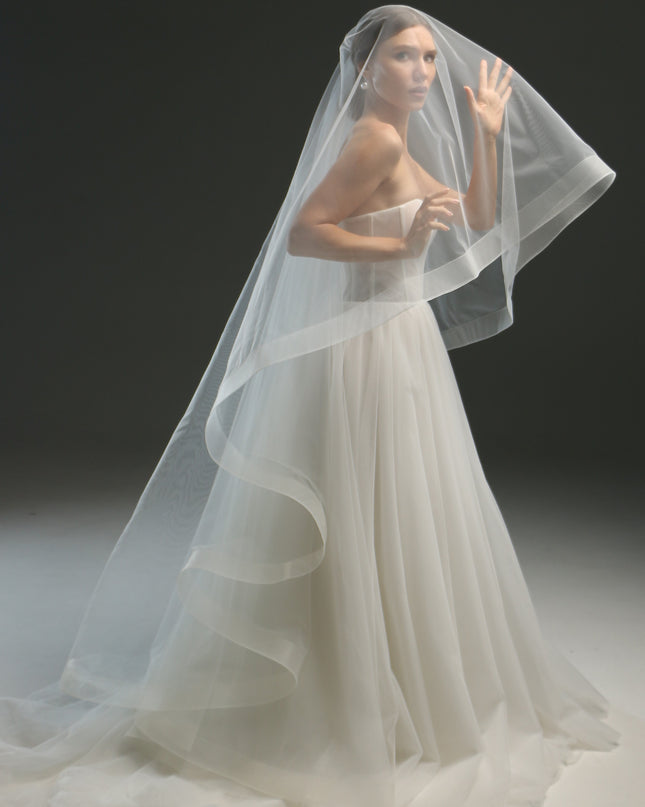 Ivory bridal veil made from soft English tulle, fingertip length, featuring two layers and a horsehair trim.