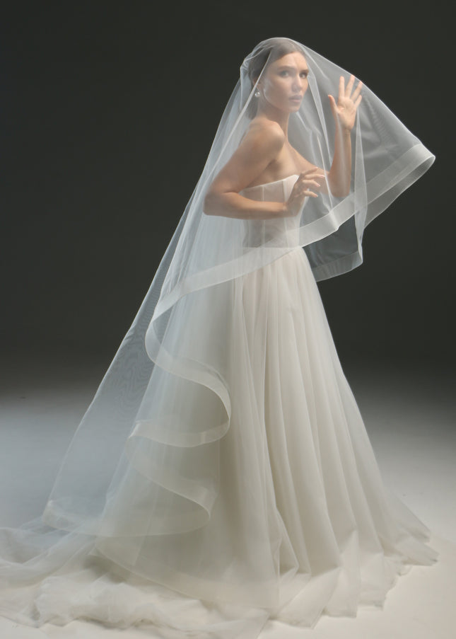 Ivory bridal veil made from soft English tulle, fingertip length, featuring two layers and a horsehair trim.