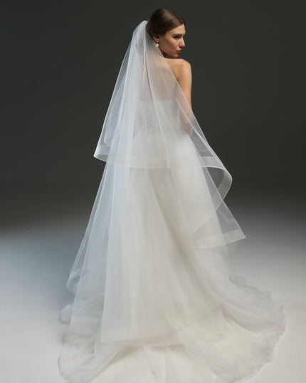 Ivory bridal veil made from soft English tulle, fingertip length, featuring two layers and a horsehair trim.
