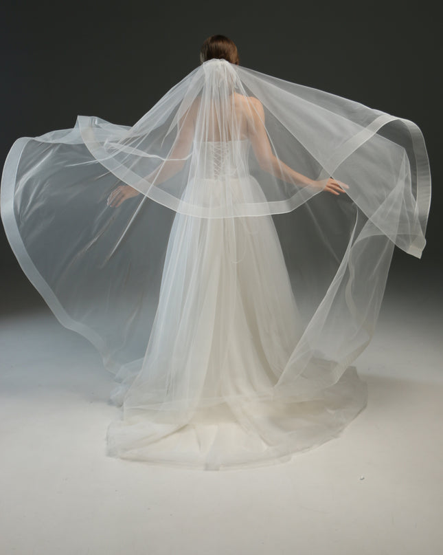 Ivory bridal veil made from soft English tulle, fingertip length, featuring two layers and a horsehair trim.