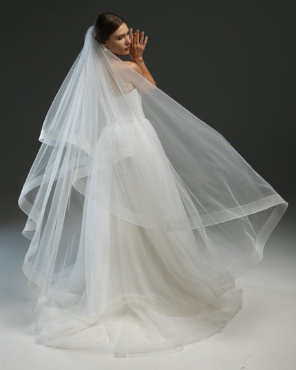 Ivory bridal veil made from soft English tulle, fingertip length, featuring two layers and a horsehair trim.