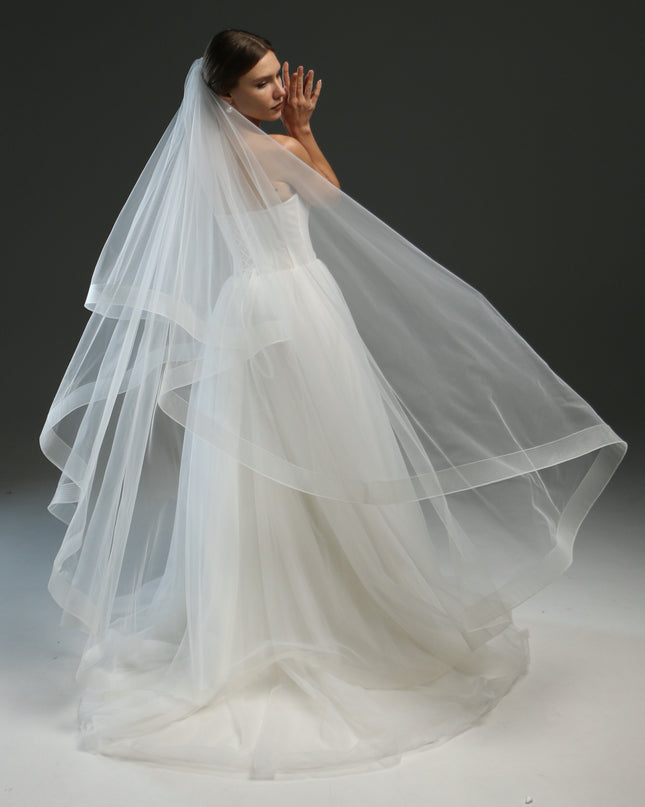 Ivory bridal veil made from soft English tulle, fingertip length, featuring two layers and a horsehair trim.