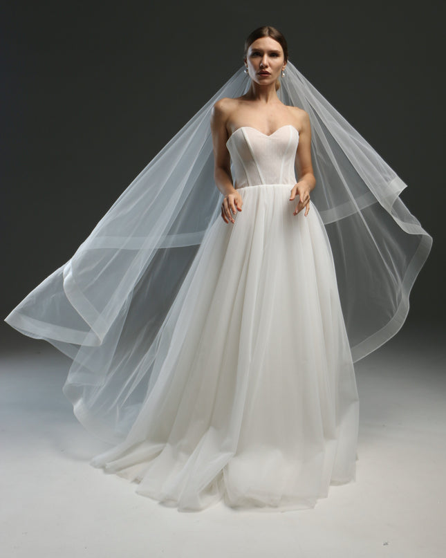 Ivory bridal veil made from soft English tulle, fingertip length, featuring two layers and a horsehair trim.